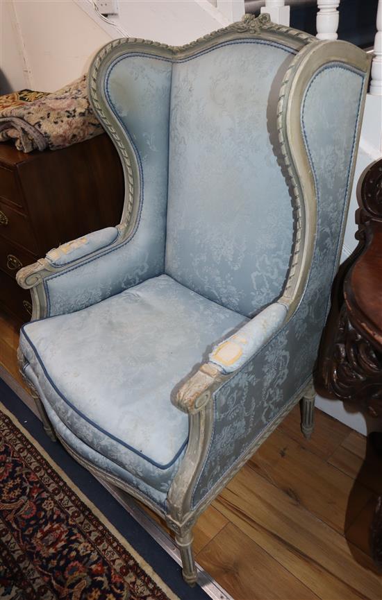 A pair of Louis XVI design grey painted armchairs, upholstered in a patterned blue fabric